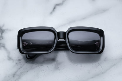 Overhead view of black rectangular sunglasses with black lenses