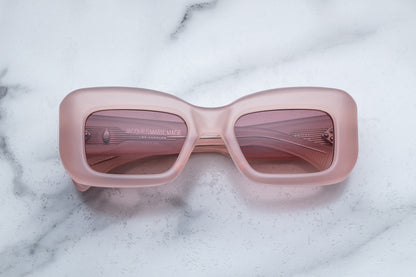 Overhead view of pink sunglasses with pink lenses
