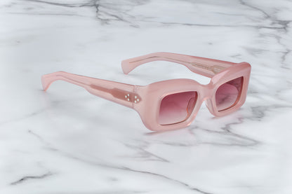 Overhead view of pink sunglasses with pink lenses