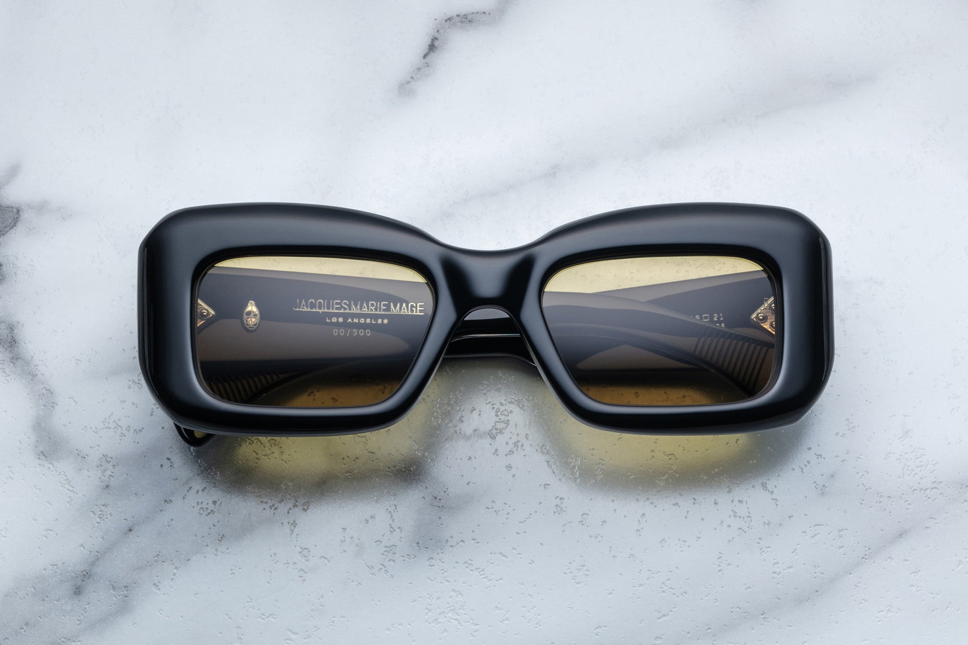 Overhead view of black sunglasses with yellow lenses