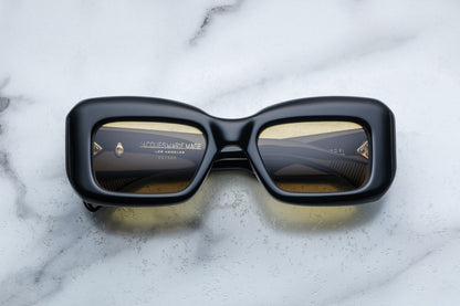 Overhead view of black sunglasses with yellow lenses