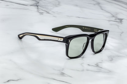 Side view of black rectangular sunglasses with green lenses