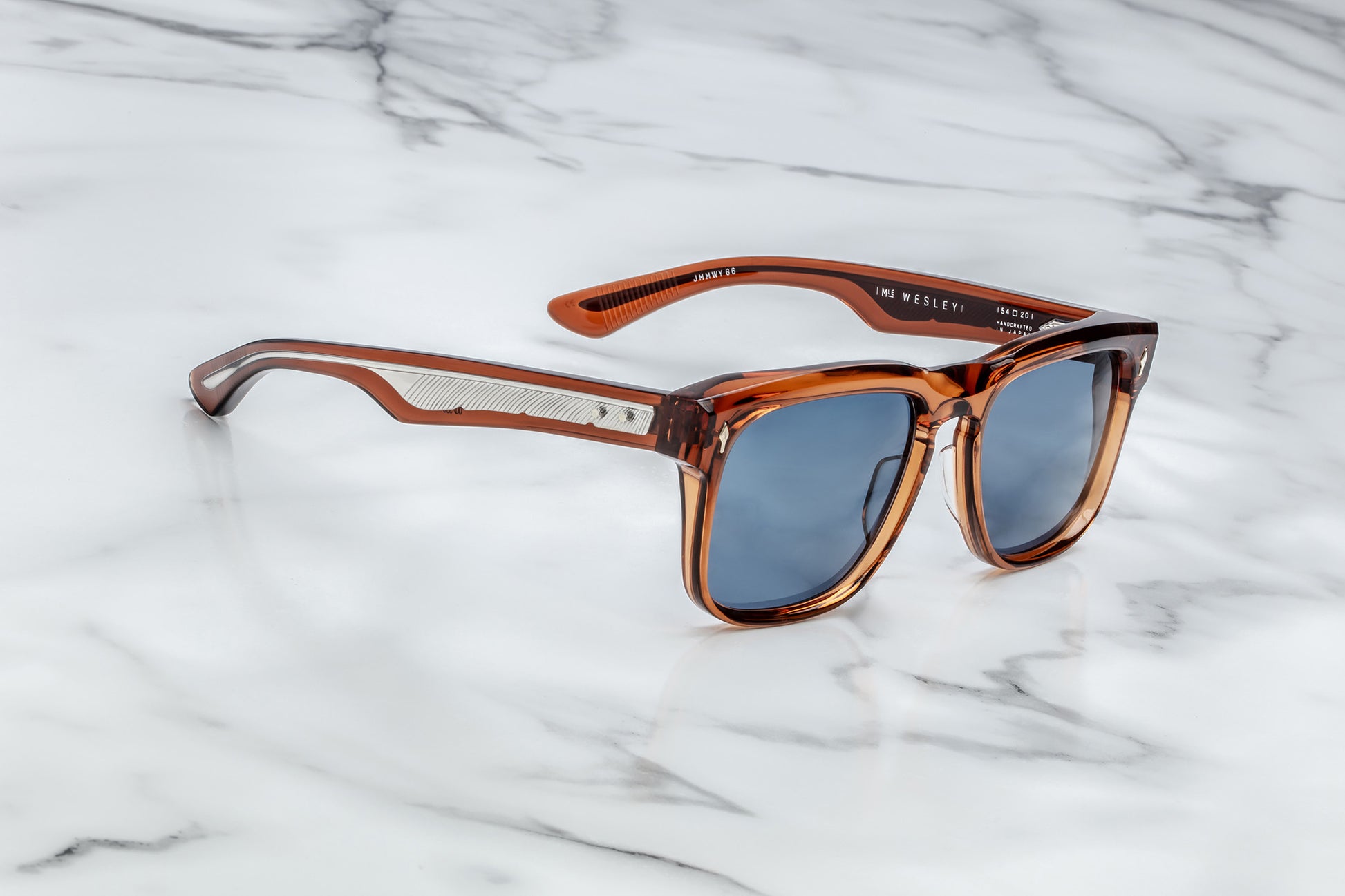 Side view of burnt orange rectangular sunglasses with blue lenses