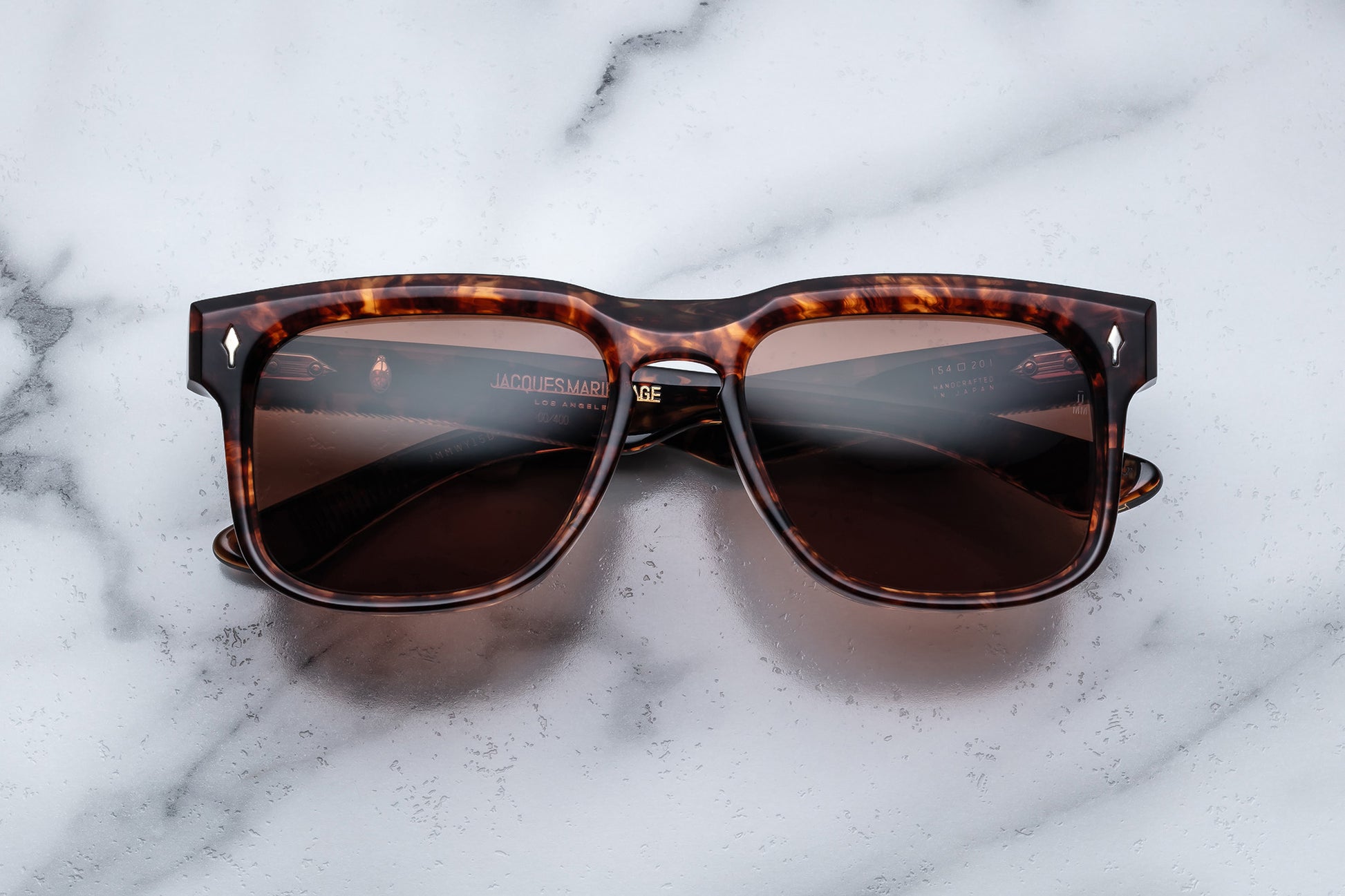 Overhead view of brown tortoise shell patterned rectangular sunglasses with brown lenses