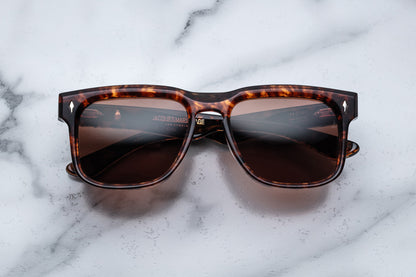 Overhead view of brown tortoise shell patterned rectangular sunglasses with brown lenses
