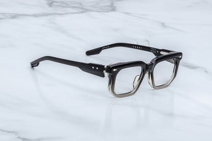 Black eyeglasses on a white marble surface