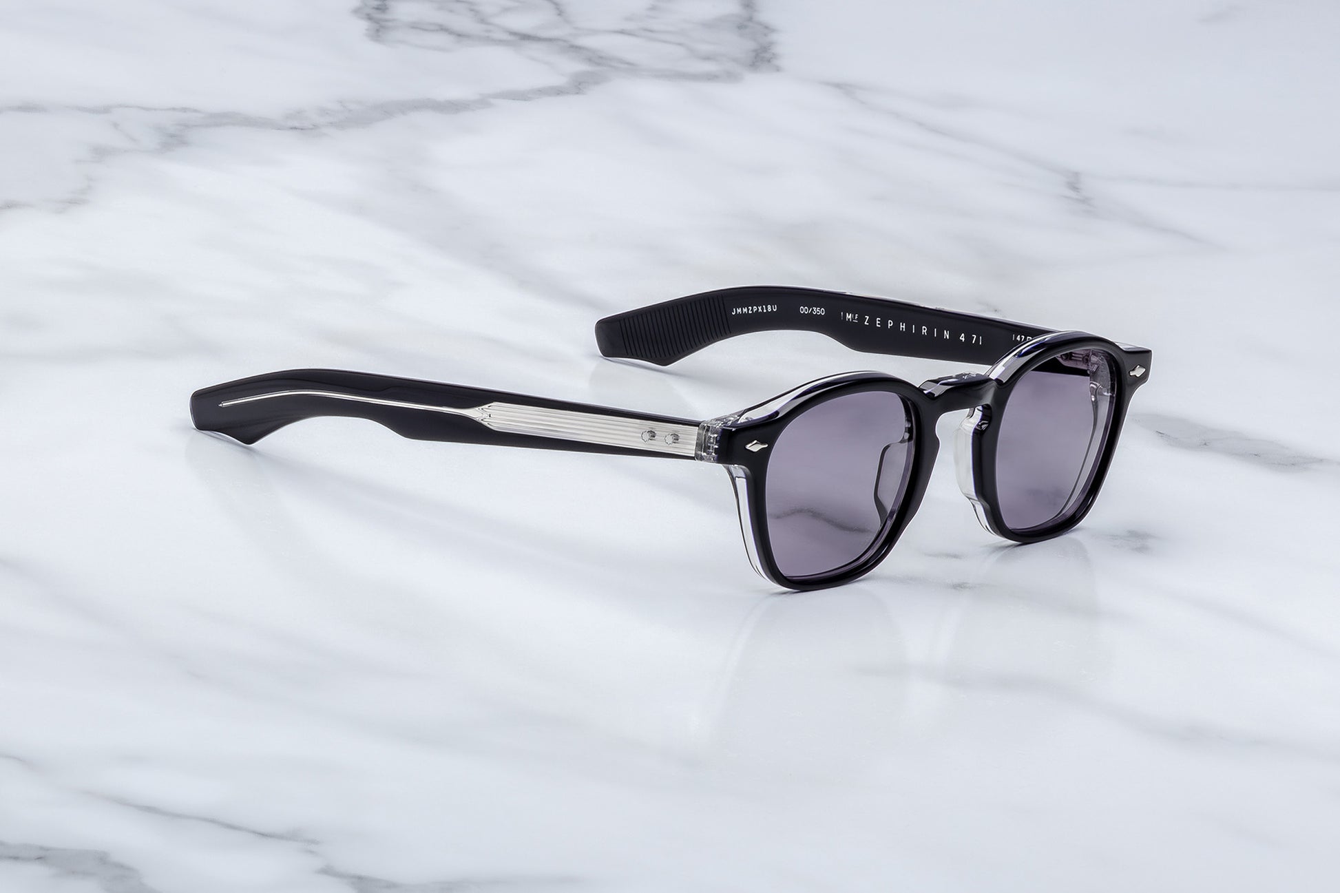 Sunglasses with a brand logo on a marble surface