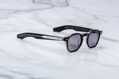 Sunglasses with a brand logo on a marble surface