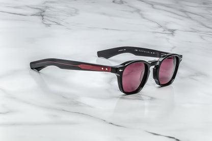 Overhead view of black rounded rectangular sunglasses with red lenses