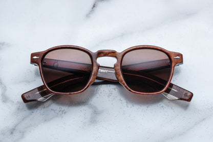 Overhead view of brown rounded rectangular sunglasses with brown lenses