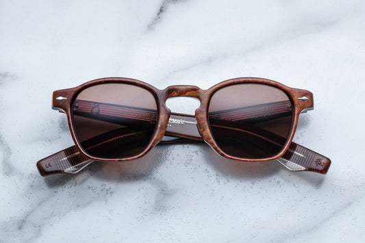 Overhead view of brown rounded rectangular sunglasses with brown lenses