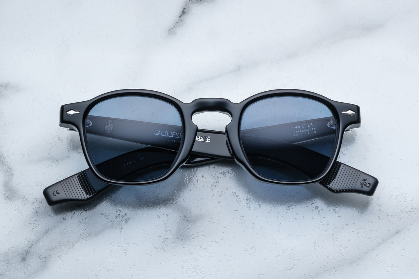 Side view of black rounded rectangular sunglasses with blue lenses