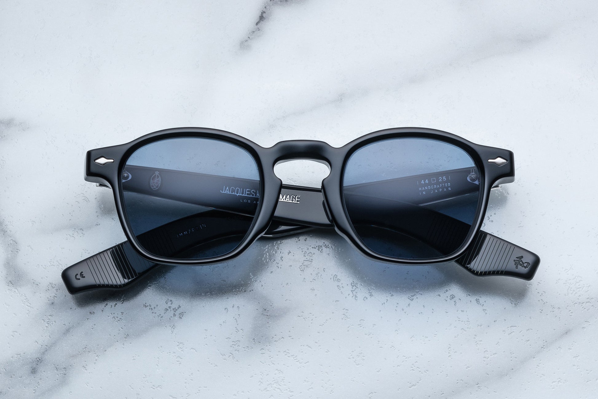 Side view of black rounded rectangular sunglasses with blue lenses