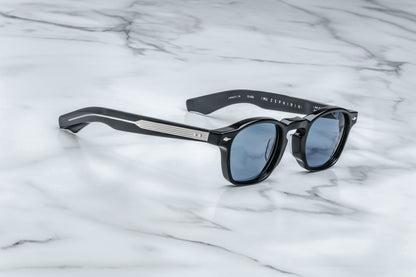 Side view of black rounded rectangular sunglasses with blue lenses