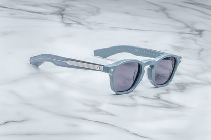 Side view of powder blue rounded rectangular sunglasses with purple lenses