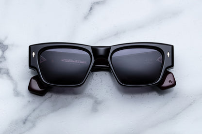 Black sunglasses with reflective lenses on a marble surface